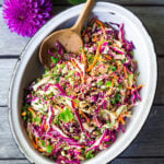 Easy Crunchy Asian Slaw- a simple vegan slaw with the BEST SLAW DRESSING EVER that can be made ahead! Serve this alongside fish, tofu, or chicken or stuffed into tacos, topped onto burgers, or added to buddha bowls. A great way to add more veggies into your everyday meals. #slaw #asianslaw #veganslaw #easyslaw #tacoslaw