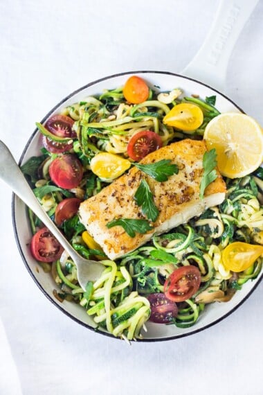 A simple, healthy Halibut recipe served over Lemony Zucchini Noodles with olive oil, garlic and Italian parsley, topped with sweet summer tomatoes. A quick and easy low-carb meal!