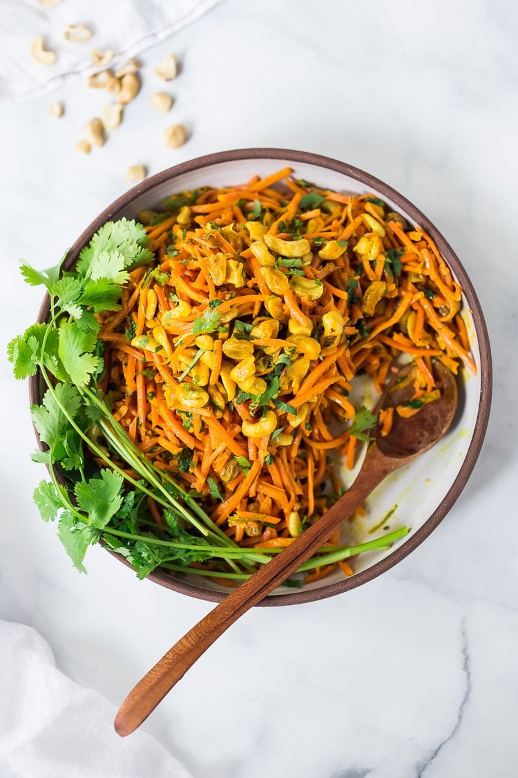 35 Best Indian Recipes: Bombay Carrot Salad with cashews and raisins, tossed in a fragrant Indian Curry dressing. Healthy and vegan this carrot salad recipe is so EASY to make, and can be made-ahead.