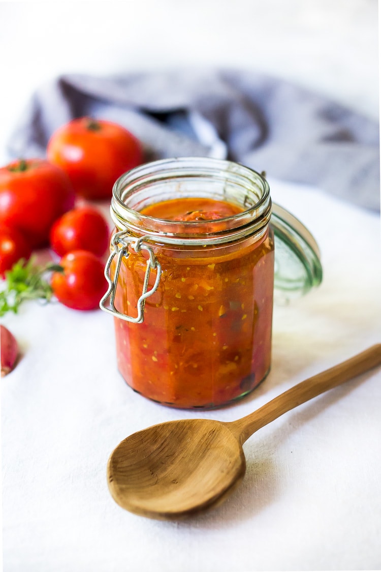 An easy recipe for Roasted Tomato Sauce made with fresh summer tomatoes, garlic and herbs.  Extend summer's harvest into winter- can be made ahead and frozen or canned. 