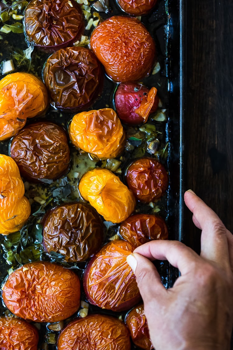 An easy recipe for Roasted Tomato Sauce made with fresh summer tomatoes, garlic and herbs.  Extend summer's harvest into winter- can be made ahead and frozen or canned. 