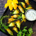 Baked Stuffed Squash Blossoms (Dolmas Style!)with ground lamb, basmati rice and fragrant Middle Eastern spices- a simple delicious main course or appetizer, inspired by the season! #dolmas #squashblossom #zucchiniblossom #squashblossoms #stuffedsquashblossom #baked #keto #paleo #lamb #lambrecipes #groundlamb