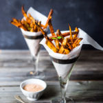 Baked Sweet Potato Fries with Harissa- crispy, healthy and so EASY! A delicious vegan side! #sweetpotato #sweetpotatofries #baked #vegan #bakedsweetpotato #harissa