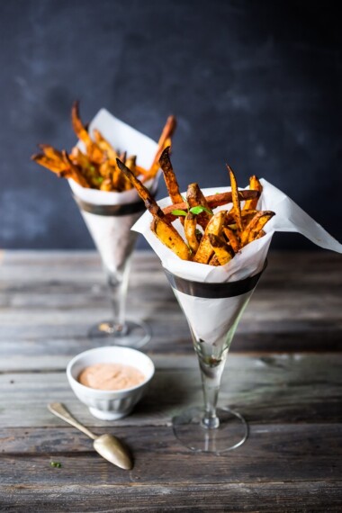 Baked Sweet Potato Fries with Harissa- crispy, healthy and so EASY! A delicious vegan side! #sweetpotato #sweetpotatofries #baked #vegan #bakedsweetpotato #harissa