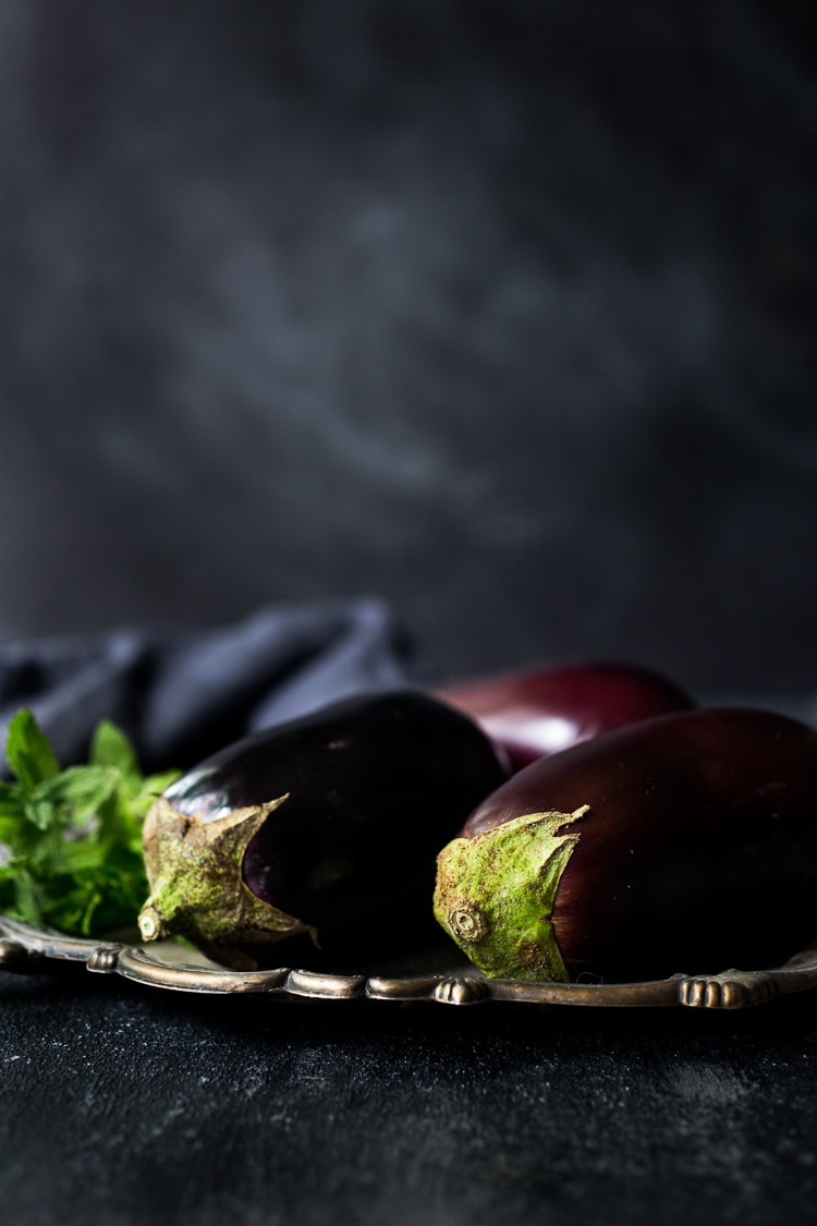 Grilled Eggplant Salad with Freekeh. Loaded up with fresh herbs and served over a tangy yogurt dressing, this healthy salad is full of Middle Eastern flavor. Vegan adaptable #freekah #eggplantsalad #freekehsalad #freekehrecipe #vegetarian #vegan #healthysalad 