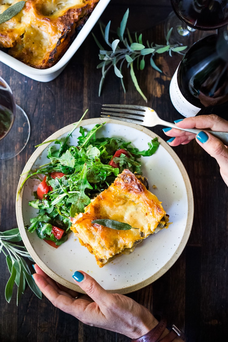 Butternut Squash Lasagna on a plat with a green salad