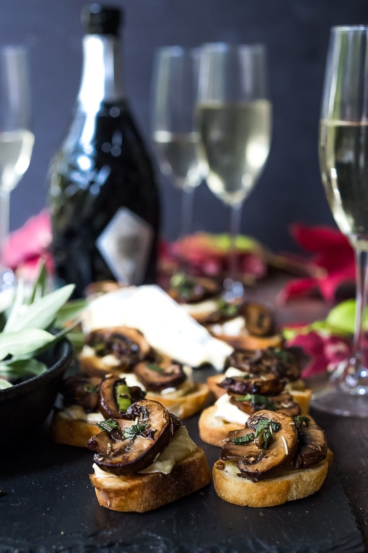 Mushroom Bruschetta with Triple Cream Brie, Sage and Truffle Oil - a surprisingly easy appetizer that tastes amazing and looks elegant! Perfect for holiday gatherings. #mushroombruschetta #mushroomappetizer #appetizer #holidayparty #holidayappetizer 