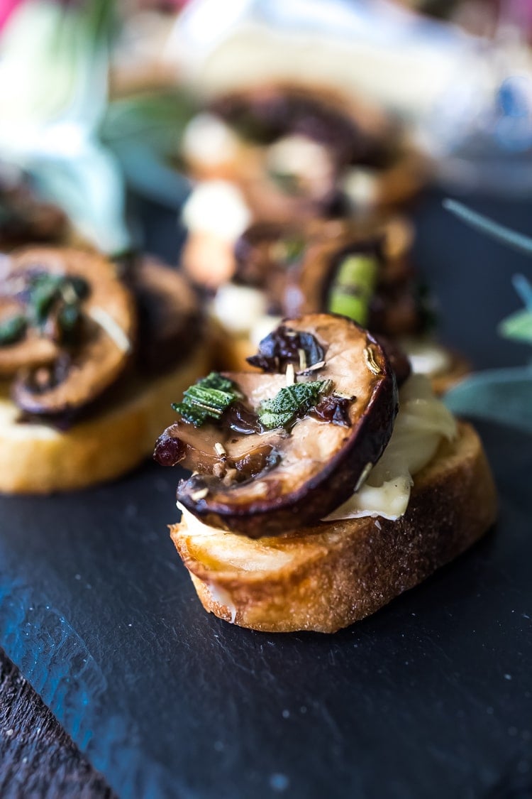 Mushroom Bruschetta with Triple Cream Brie, Sage and Truffle Oil - a surprisingly easy appetizer that tastes amazing and looks elegant! Perfect for holiday gatherings. #mushroombruschetta #mushroomappetizer #appetizer #holidayparty #holidayappetizer