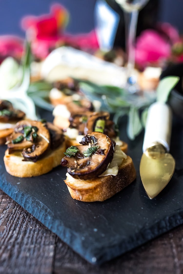 Mushroom Bruschetta with Triple Cream Brie, Sage and Truffle Oil - a surprisingly easy appetizer that tastes amazing and looks elegant! Perfect for holiday gatherings. #mushroombruschetta #mushroomappetizer #appetizer #holidayparty #holidayappetizer #veganbruschetta #glutenfreebruschetta #veganmushroombruschetta #truffleoil #brieappetizer #christmasappetizer 