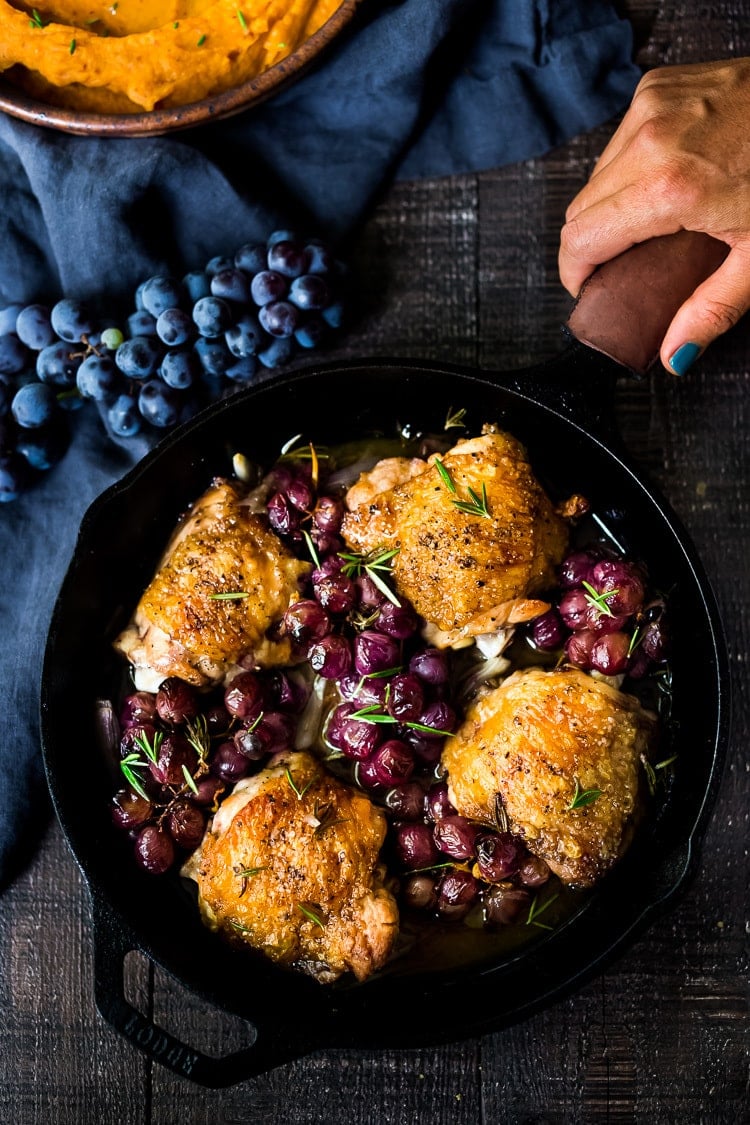 A delicious recipe for Pan-Roasted Chicken with Grapes.  Chicken thighs are pan-seared in a skillet,  then baked in the oven with grapes and shallots. A fast and simple weeknight dinner.