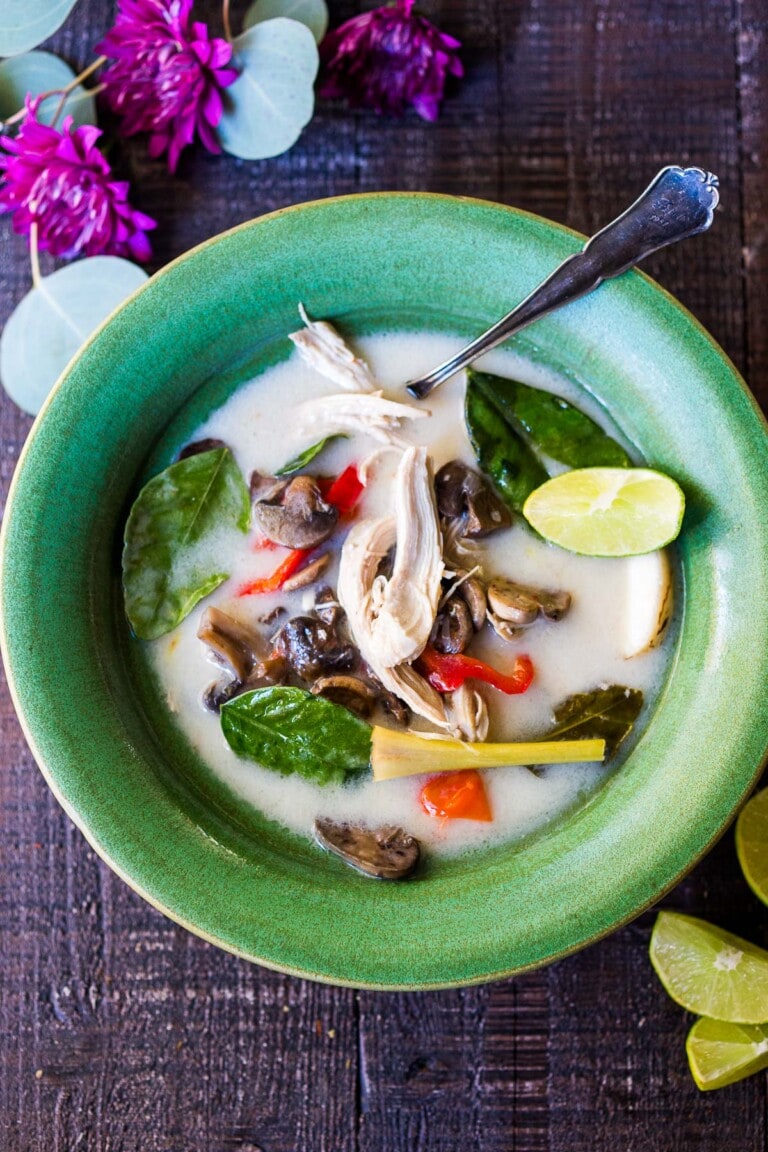 This Tom Kha Soup recipe (Thai coconut soup) is pure comfort in a bowl! Rich and creamy, tangy and salty, it's completely delicious! Make it with chicken or tofu, on the stovetop or in your instant pot! Video.