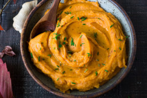 A quick and healthy recipe for Whipped Sweet Potatoes with Ginger - a flavorful vegan side dish that pairs well with fish, chicken or vegan mains. Silky and luscious, these flavorful sweet potatoes can be made in under 30 minutes! #sweetpotatoes #vegan #healthy #mashed