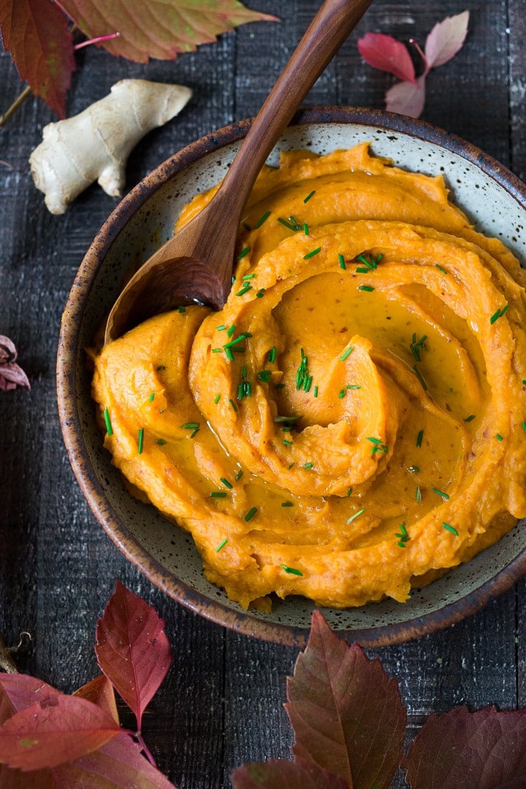 A quick and healthy recipe for Whipped Sweet Potatoes with Ginger - a flavorful vegan side dish that pairs well with fish, chicken or vegan mains. Silky and luscious, these flavorful sweet potatoes can be made in under 30 minutes! #sweetpotatoes #vegan #healthy #mashed 