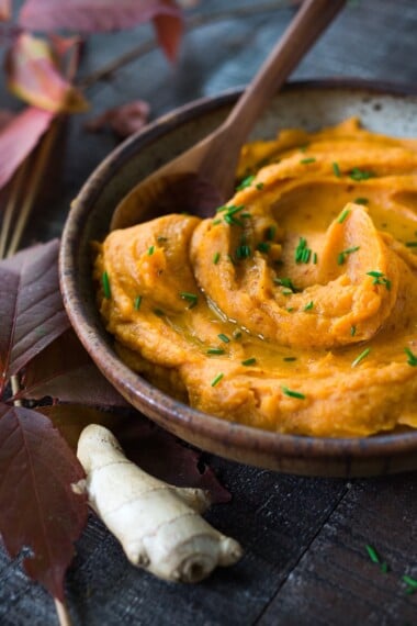 A quick and healthy recipe for Whipped Sweet Potatoes with Ginger - a flavorful vegan side dish that pairs well with fish, chicken or vegan mains. Silky and luscious, these flavorful sweet potatoes can be made in under 30 minutes! #sweetpotatoes #vegan #healthy #mashed