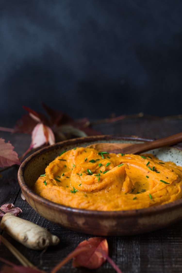 A quick and healthy recipe for Whipped Sweet Potatoes with Ginger - a flavorful vegan side dish that pairs well with fish, chicken or vegan mains. Silky and luscious, these flavorful sweet potatoes can be made in under 30 minutes! #sweetpotatoes #vegan #healthy #mashed 