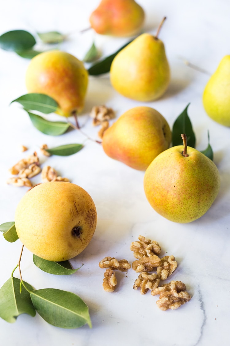 pears and walnuts scattered on countertop.