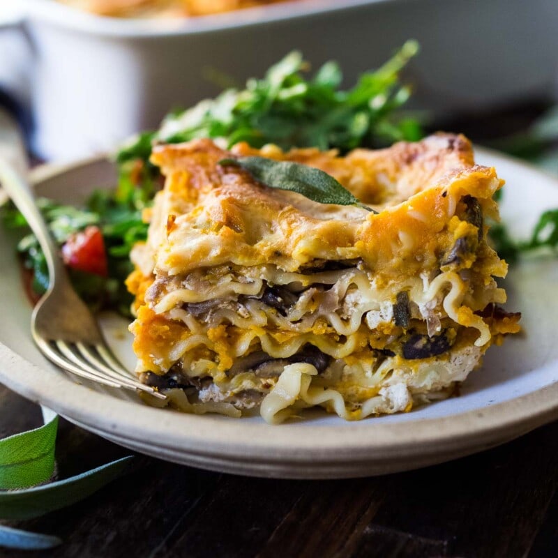 This Butternut Squash Lasagna recipe is a cozy and heartwarming vegetarian meal, made with a creamy roasted butternut squash sauce, no-boil noodles, mushrooms, spinach, ricotta, and crispy sage. Video + Vegan-adaptable.