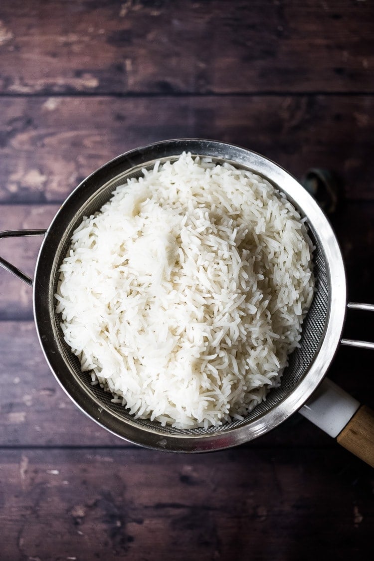 How to cook perfectly FLUFFY Indian Basmati Rice, just like they do in India! Finished with a flavorful tempering oil this rice is nothing short of delicious! Fast, easy and vegan-adaptable. 