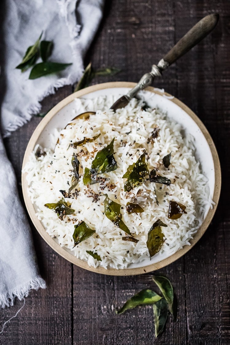 How to cook perfectly FLUFFY Indian Basmati Rice, just like they do in India! Finished with a flavorful tempering oil this rice is nothing short of delicious! Fast, easy and vegan-adaptable. 