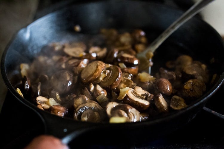 mushrooms cooking in a skillet. 