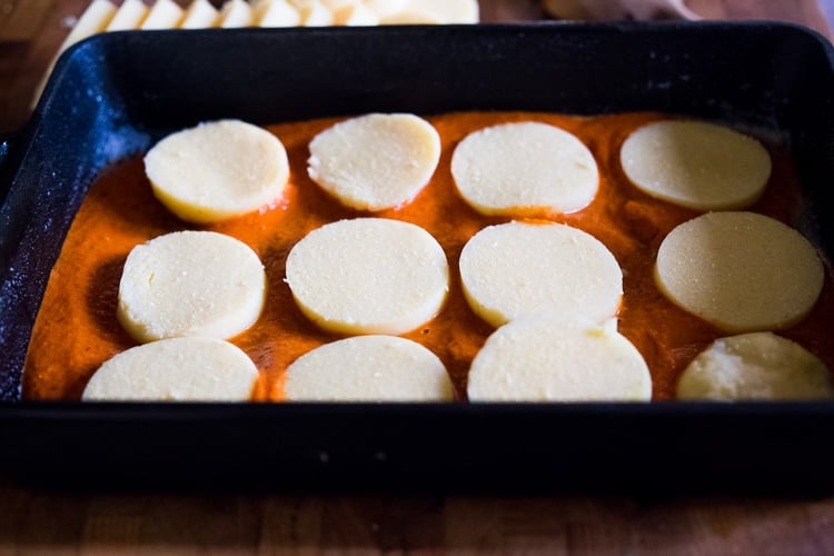 assembling the lasagna with polenta. 