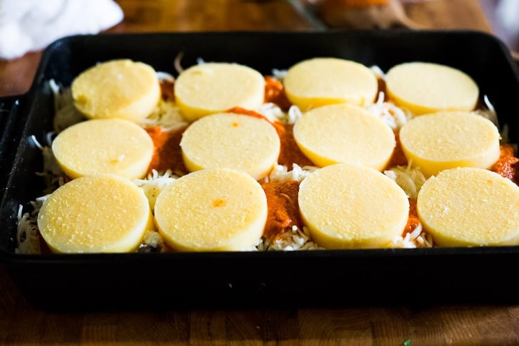 assembling the lasagna - adding the final layer of polenta. 