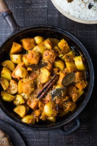 North Indian Butternut and Potato Curry, served over fluffy Basmati Rice. Subtle flavor, soothing and comforting. | #indiancurry #vegetarian #butternut #aloo #rajisthanifood #potatocurry #currypotaotes