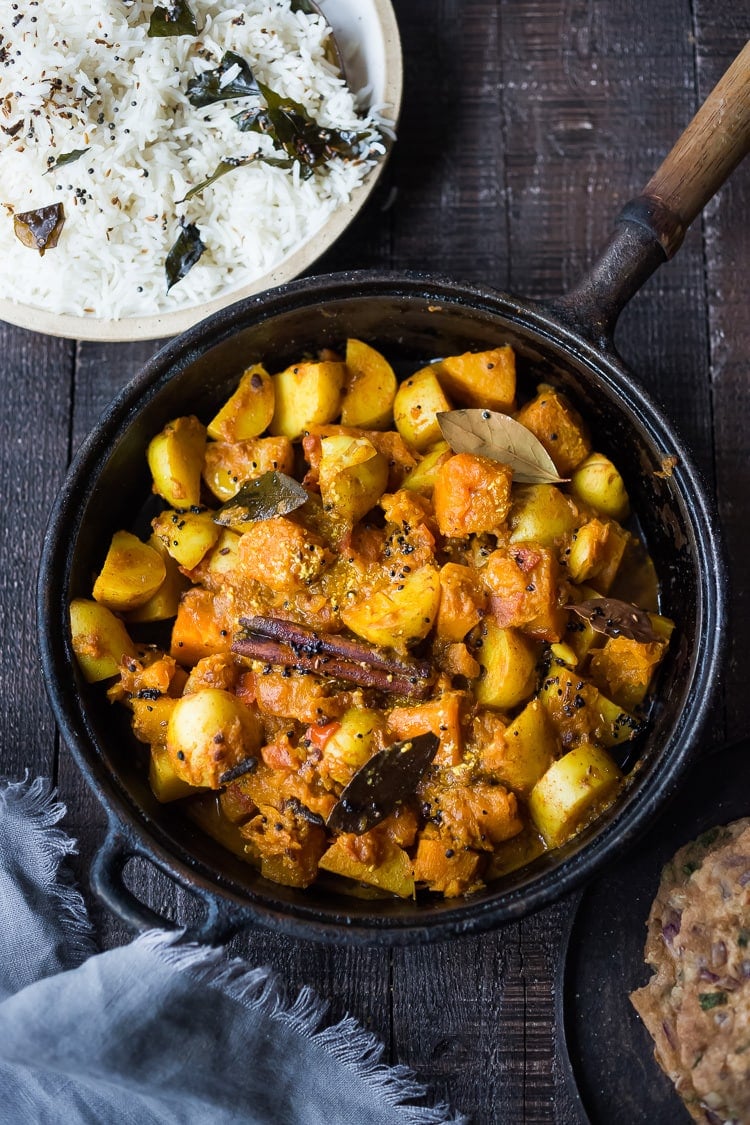 A soothing and comforting North Indian Butternut and Potato Curry hailing from Rajasthan, featuring winter squash and potatoes, using whole spices and ghee, served over fluffy basmati rice. | #pumpkincurry #potatocurry #aloo #butternutcurry #rajisthani #kaddu #curriedpotatoes #vegetarain #indianfood 