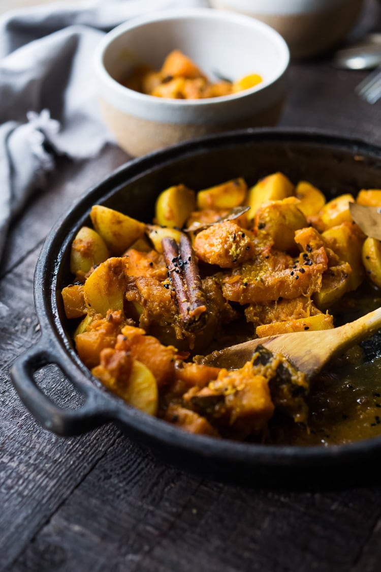 A soothing and comforting North Indian Butternut and Potato Curry hailing from Rajasthan, featuring winter squash and potatoes, using whole spices and ghee, served over fluffy basmati rice. | #pumpkincurry #potatocurry #aloo #butternutcurry #rajisthani #kaddu #curriedpotatoes #vegetarain #indianfood 