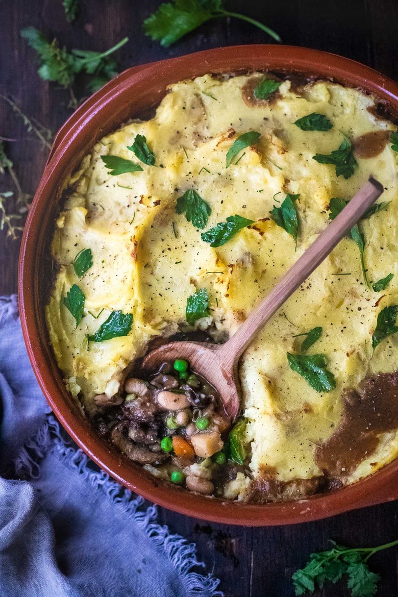 Vegan Shepherds Pie with mushrooms and root vegetables- topped with pillowy mashed potatoes. A delicious vegan main dish -perfect for the holiday table. #sheperdspie #vegan