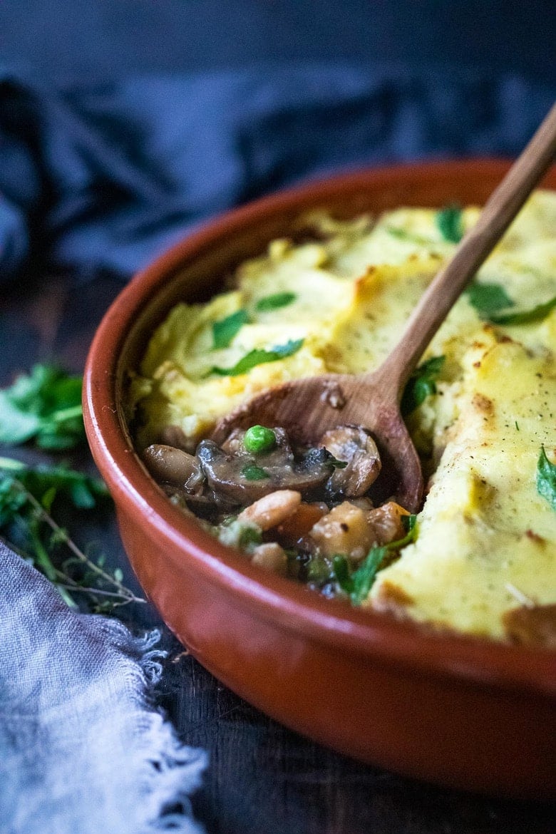 Vegan Shepherds Pie with mushrooms and root vegetables- topped with pillowy mashed potatoes. A delicious vegan main dish -perfect for the holiday table. #sheperdspie #vegan