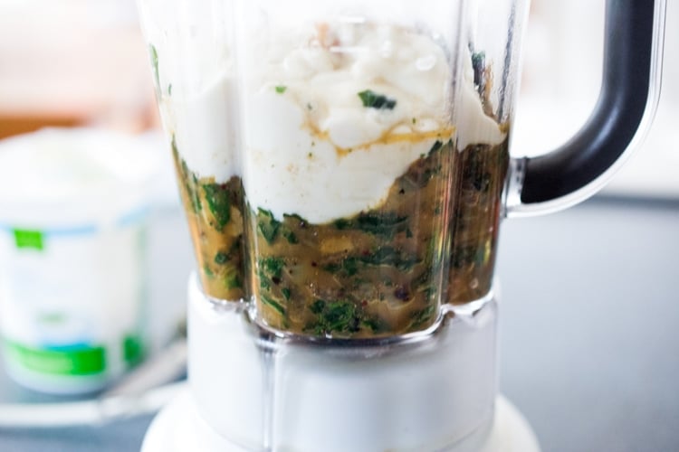 blending the spinach mixture with water and yogurt in a blender