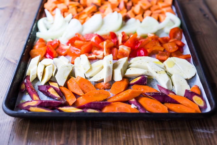 The secret to making Simple Roasted Veggies in the oven that come out perfect every time. Easy, healthy, delicious! Vegan and Gluten-free. #roastedveggies #roastedvegetables #bakedvegetables #vegan #healthy #veganside #glutenfree #feastingathome #sheetpanvegetables 