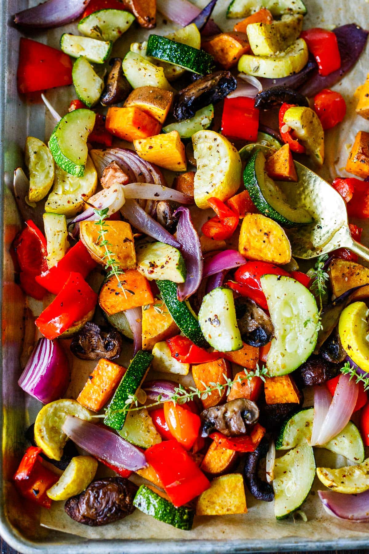Roasted vegetables seasoned on a sheet pan right out of the oven. 