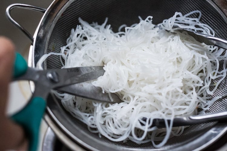 Cutting soaked rice noodles for Singapore noodles.