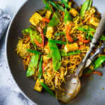 Singapore noodles— stir-fried rice noodles with curry, tofu and vegetables—a Chinese take out menu classic - easy recipe, vegetarian and full of authentic flavor! #meifun #singaporenoodles #currynoodles #chinesenoodles #stirfry #stirfrynoodles #vegetarian #noodles