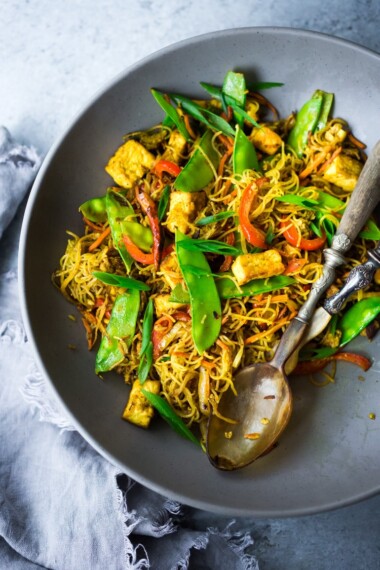 Singapore noodles— stir-fried rice noodles with curry, tofu and vegetables—a Chinese take out menu classic - easy recipe, vegetarian and full of authentic flavor! #meifun #singaporenoodles #currynoodles #chinesenoodles #stirfry #stirfrynoodles #vegetarian #noodles