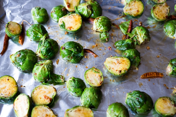 Sheet-Pan Szechuan Chicken (or Tofu) with Brussel Sprouts  takes only 15-20 minutes of hands on time before baking in the oven. A full-flavored weeknight dinner your whole family will love!  #sheetpandinner #szechuanchicken #szechuan #szechuansauce #sheetpanchicken #roastedbrusselsprouts