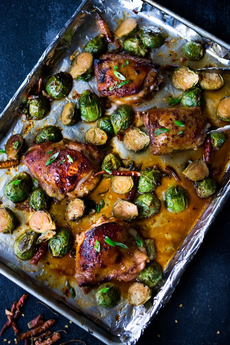 Sheet-Pan Szechuan Chicken (or Tofu) with Brussels Sprouts takes only 15-20 minutes of hands on time before baking in the oven. A full-flavored weeknight dinner your whole family will love! #sheetpandinner #szechuanchicken #szechuan #szechuansauce #sheetpanchicken #roastedbrusselsprouts