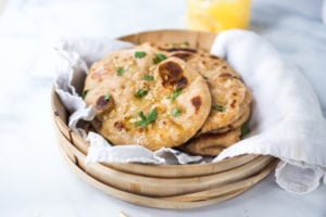 Quick EASY Homemade Naan Bread Recipe- a simple step by step guide to making Indian style- pillowy naan bread in a skillet with all your favorite variations- garlic naan, onion naan and seeded naan! #feastingathome #naan #naanbread #indianfood #wholewheatnaan #garlicnaan #onionnaan #indianbread #indianrecipes