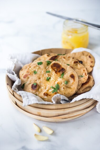 Quick EASY Naan Recipe - step by step instructions to making traditional Naan in a skillet - soft, pillowy and crispy- with all your favorite toppings- garlic naan, onion naan and seeded naan! #feastingathome #naan #naanbread #indianfood #wholewheatnaan #garlicnaan #onionnaan #indianbread #indianrecipes