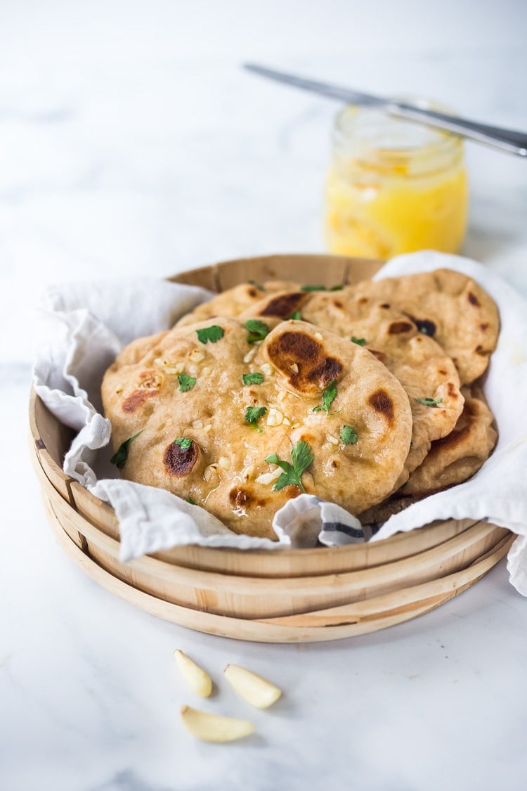 Quick EASY Naan Recipe - step by step instructions to making traditional Naan in a skillet - soft, pillowy and crispy- with all your favorite toppings- garlic naan, onion naan and seeded naan! #feastingathome #naan #naanbread #indianfood #wholewheatnaan #garlicnaan #onionnaan #indianbread #indianrecipes 