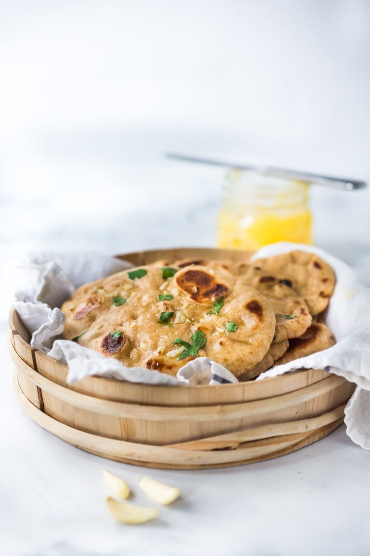 Easy Naan Recipe- simple step by step instructions to making traditional, pillowy, crispy naan bread in a skillet with all your favorite toppings - garlic naan, onion naan and seeded naan! #feastingathome #naan 