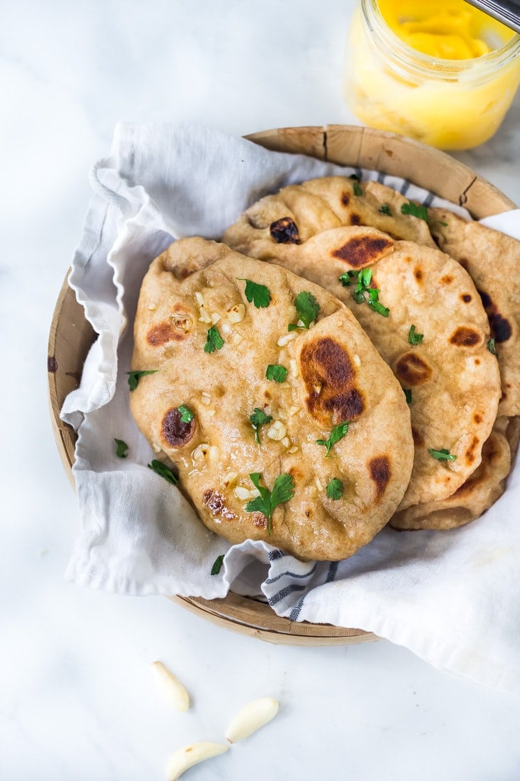 Quick EASY Naan Recipe - step by step instructions to making traditional Naan in a skillet - soft, pillowy and crispy- with all your favorite toppings- garlic naan, onion naan and seeded naan! #feastingathome #naan #naanbread #indianfood #wholewheatnaan #garlicnaan #onionnaan #indianbread #indianrecipes 