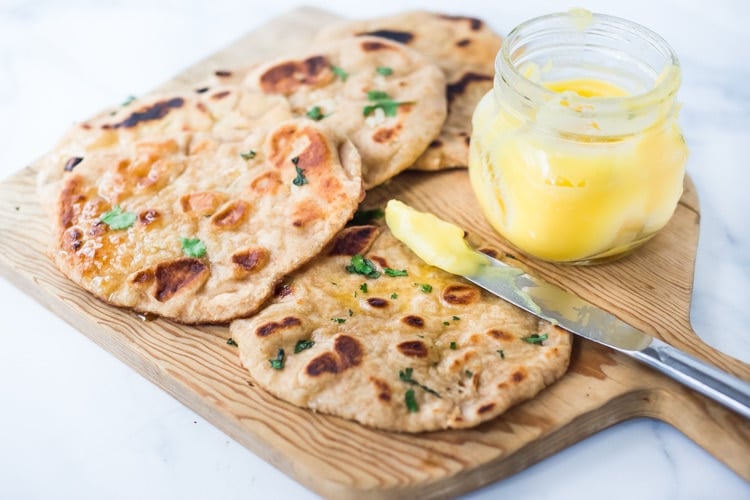 Quick EASY Naan Recipe - step by step instructions to making traditional Naan in a skillet - soft, pillowy and crispy- with all your favorite toppings- garlic naan, onion naan and seeded naan! #feastingathome #naan #naanbread #indianfood #wholewheatnaan #garlicnaan #onionnaan #indianbread #indianrecipes
