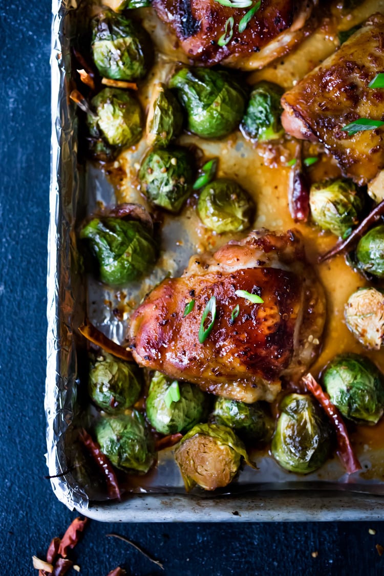 Sheet-Pan Szechuan Chicken (or Tofu) with Brussel Sprouts  takes only 15-20 minutes of hands on time before baking in the oven. A full-flavored weeknight dinner your whole family will love!  #sheetpandinner #szechuanchicken #szechuan #szechuansauce #sheetpanchicken #roastedbrusselsprouts