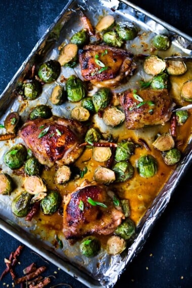 Sheet-Pan Szechuan Chicken (or Tofu) with Brussel Sprouts  takes only 15-20 minutes of hands on time before baking in the oven. A full-flavored weeknight dinner your whole family will love!  #sheetpandinner #szechuanchicken #szechuan #szechuansauce #sheetpanchicken #roastedbrusselsprouts