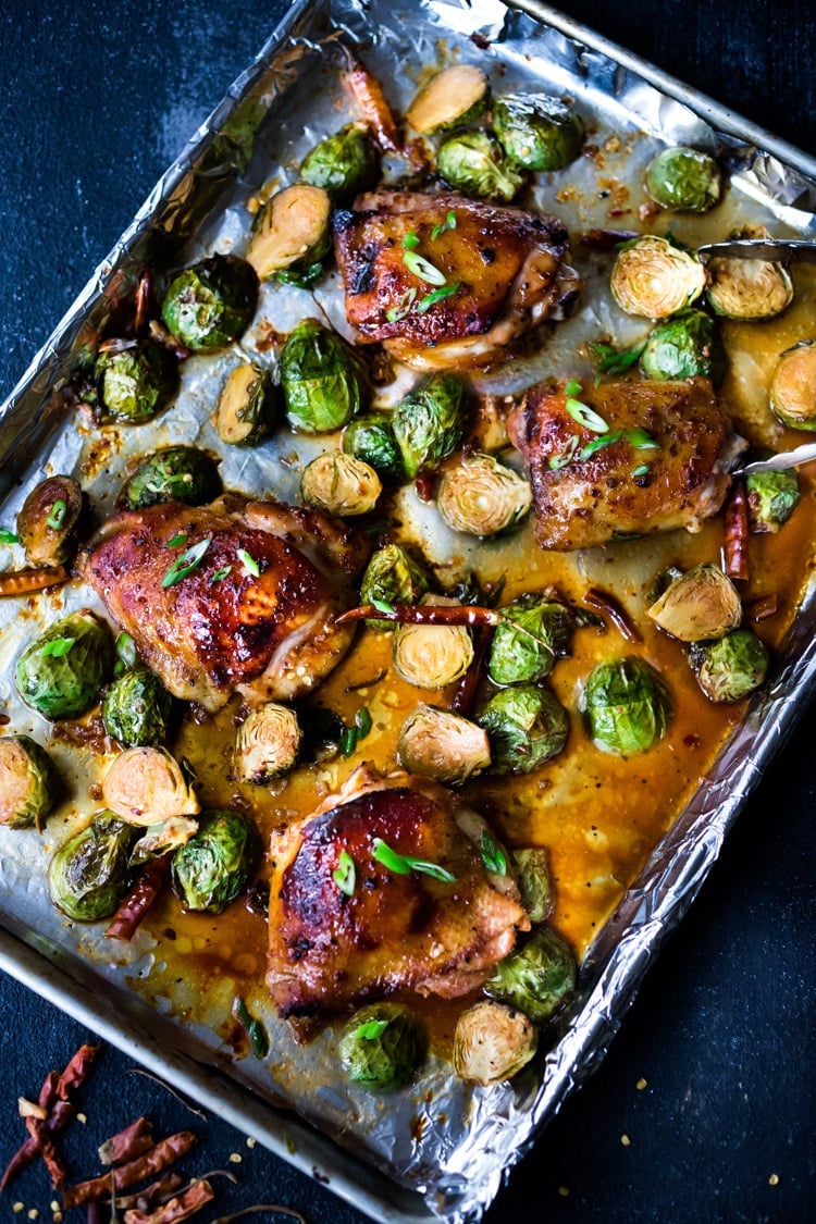 25 Sheet-Pan Dinners! | Szechuan Chicken (or Tofu) with Brussel Sprouts  takes only 15-20 minutes of hands on time before baking in the oven. A full-flavored weeknight dinner your whole family will love!  #sheetpandinner #szechuanchicken #szechuan #szechuansauce #sheetpanchicken #roastedbrusselsprouts