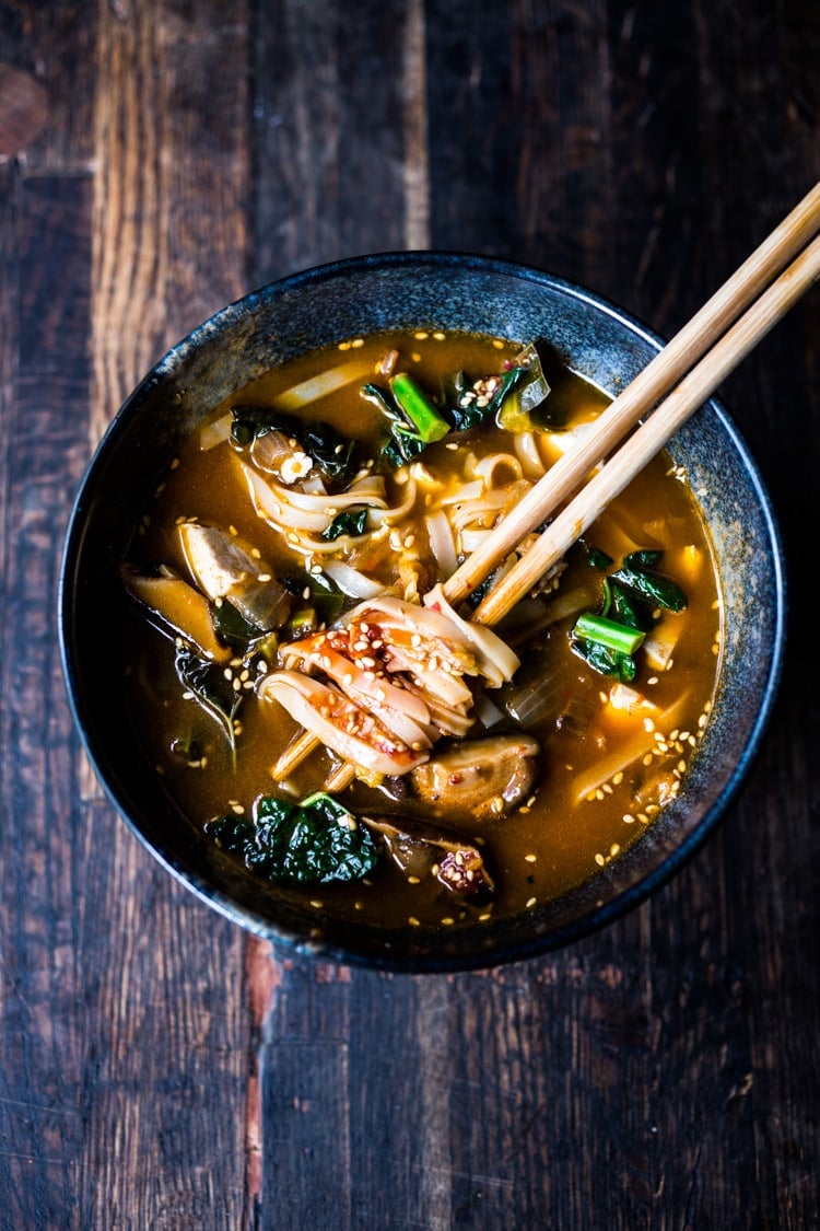 A simple easy recipe for Kimchi Soup- this version is vegan, made with shiitake mushrooms, silken tofu and kale. Serve over rice or noodles! Delicious Korean flavor! #kimchisoup #easykimchisoup #vegankimchisoup #plantbased #cleaneating #eatclean #vegansoup #koreansoup 
