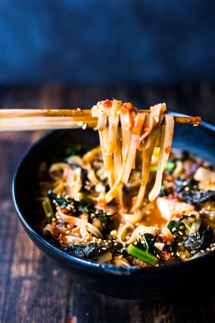 A simple easy recipe for Kimchi Soup- this version is vegan, made with shiitake mushrooms, silken tofu and kale. Serve over rice or noodles! Delicious Korean flavor! #kimchisoup #easykimchisoup #vegankimchisoup #plantbased #cleaneating #eatclean #vegansoup #koreansoup 